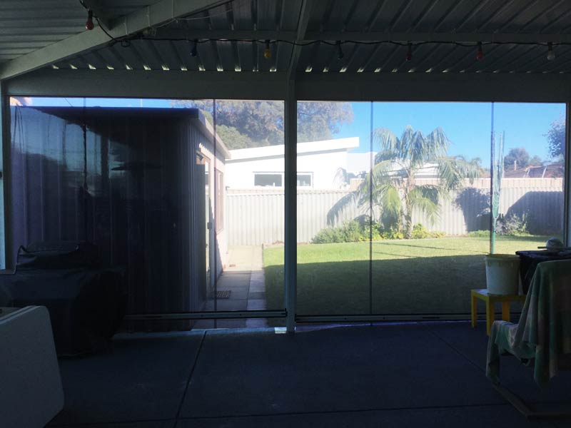 back patio fitted with clear blinds.