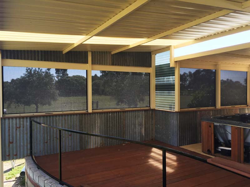 covered patio deck with blinds for sun, rain and wind protection.