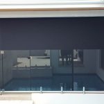 wide outdoor blind with pool behind